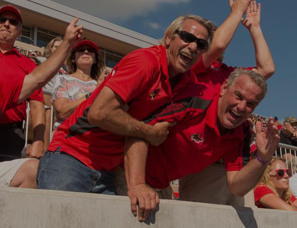 Dads cheering at a football game